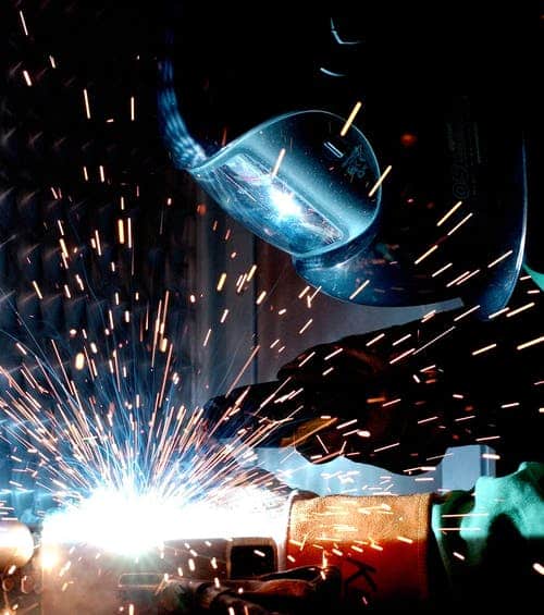 Man welding creating common workplace Fire Prevention our fire protection services