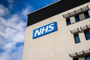 NHS building against blue sky background