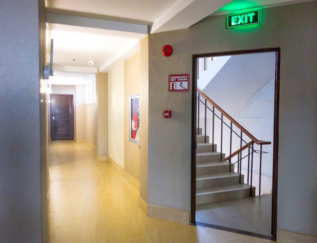 fire exit sign and staircase with fire alarms