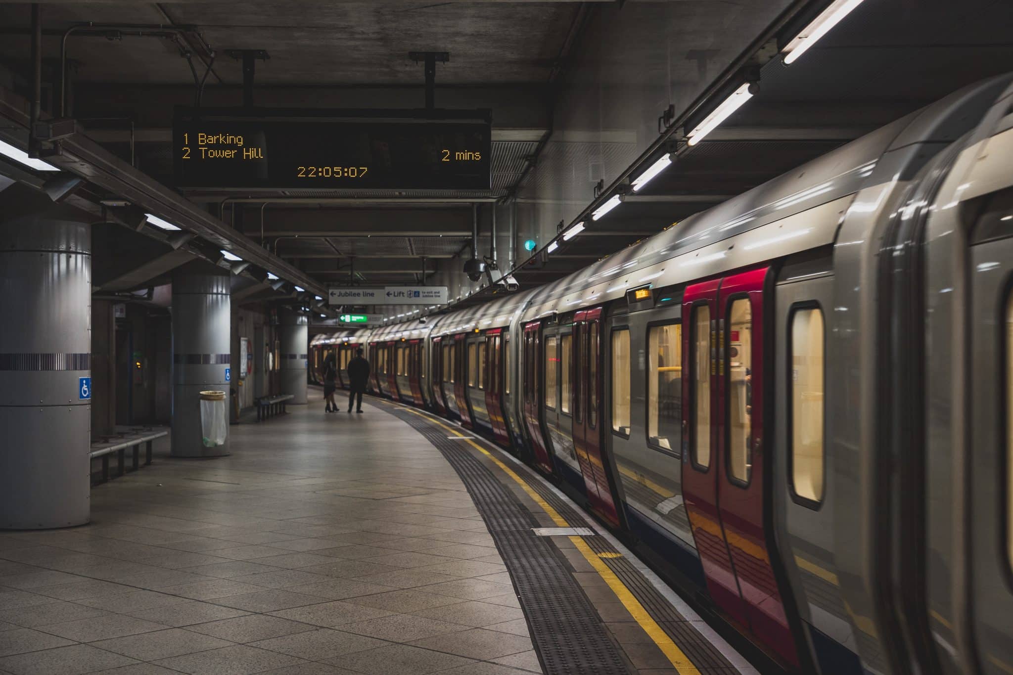 Train station platform with a train parked up on the right