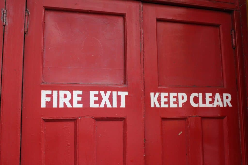 Red fire exit door with keep clear text