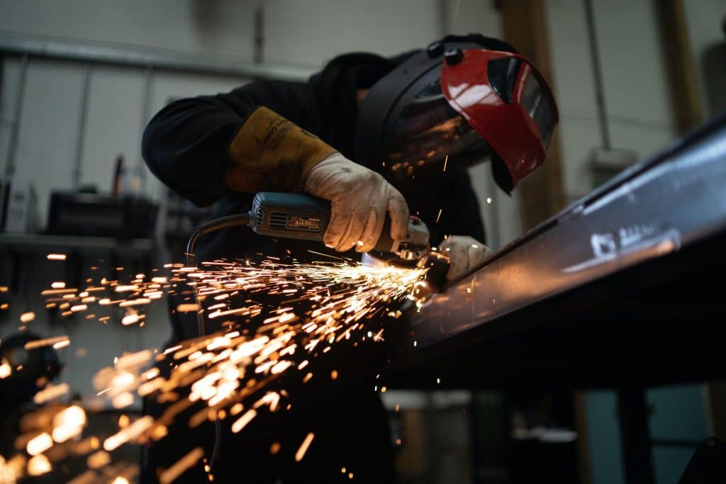 Worker with protective facemask manufacturing materials