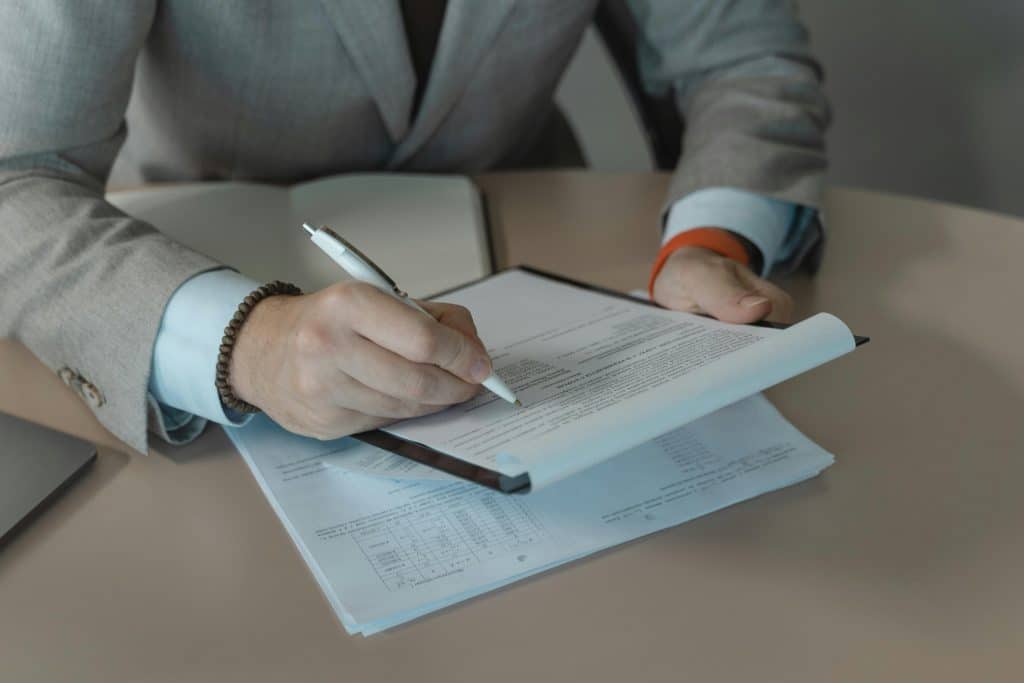 Business man writing through a document