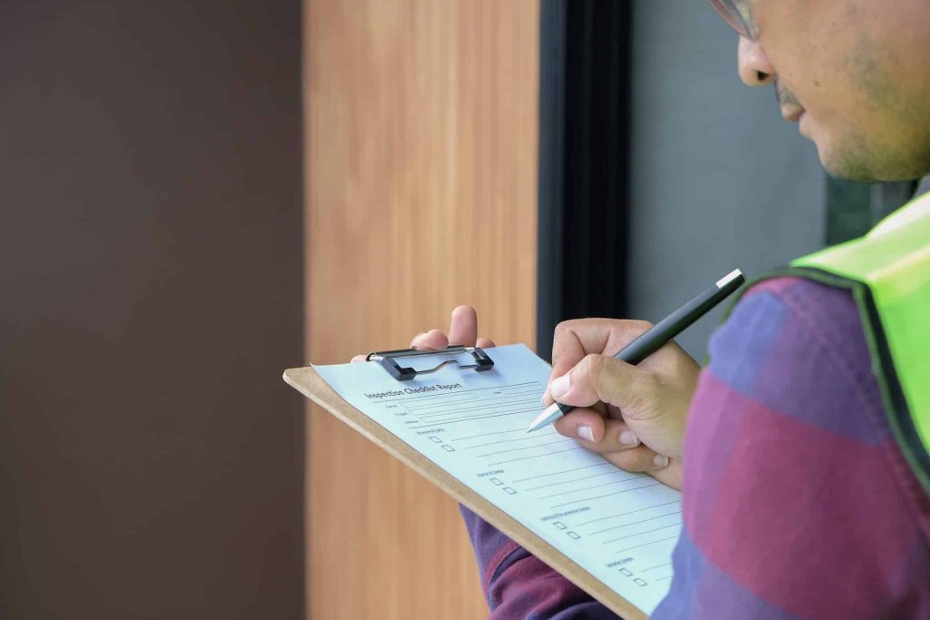 Why Get a Fire Compartmentation Survey? a professional completing a survey