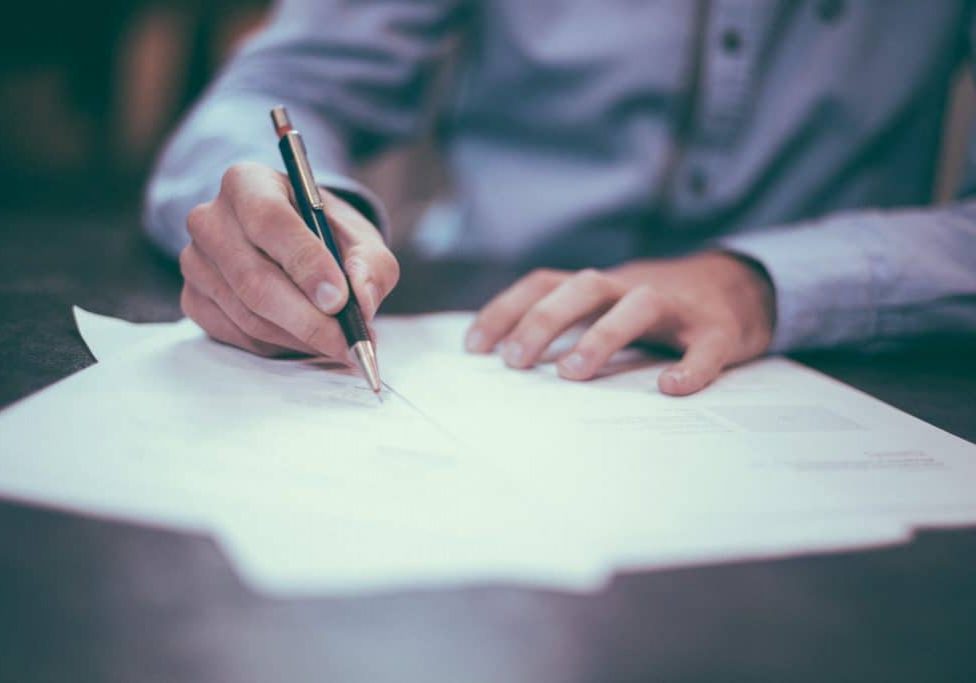 Man writing important fire safety documents