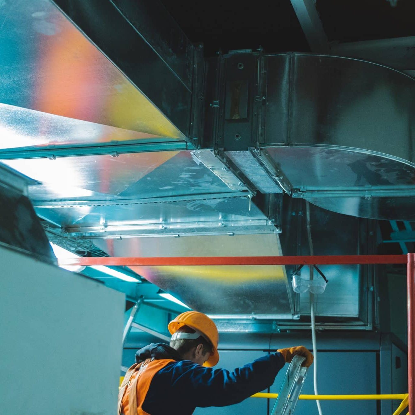a man using ladders to implement fire stopping services from element pfp